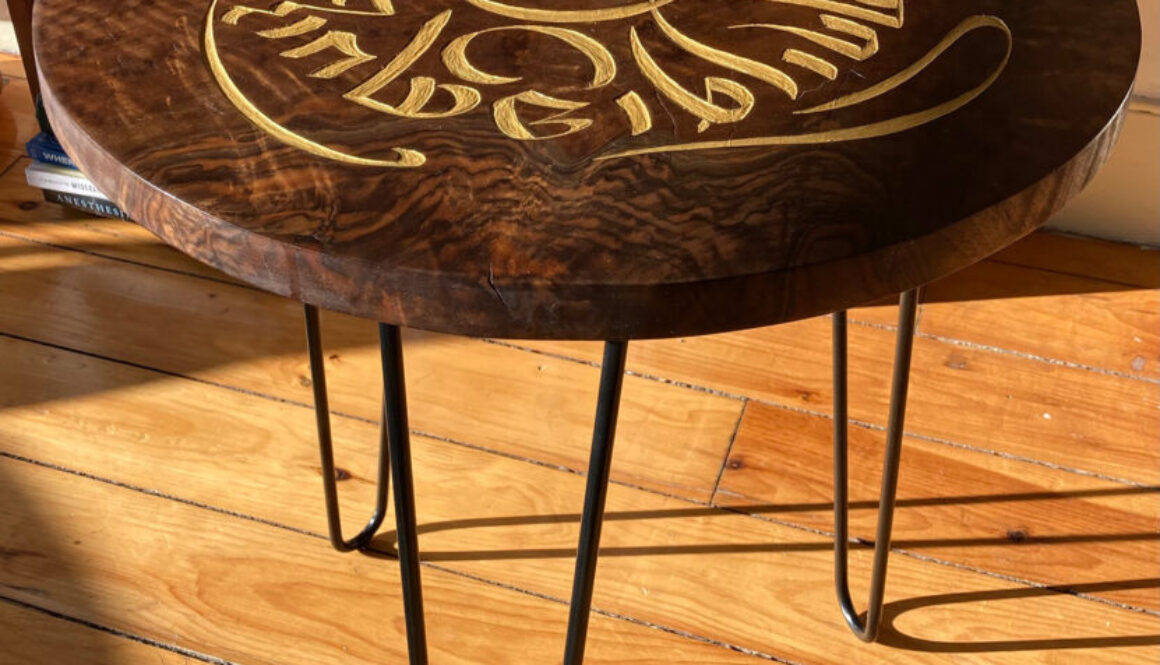 A side table with the phrase “graceful kindness” in Tibetan