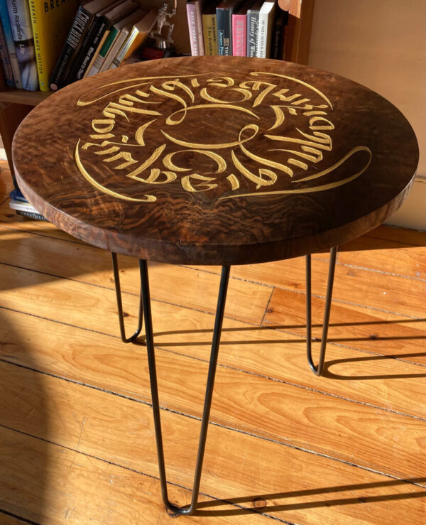 A side table with the phrase “graceful kindness” in Tibetan